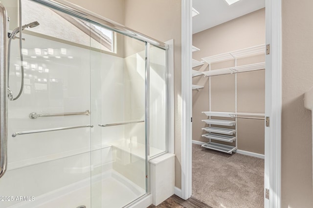 bathroom featuring a shower with shower door