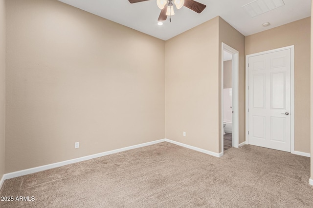 spare room featuring ceiling fan and carpet flooring