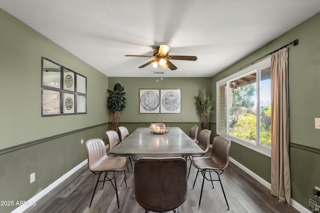 dining space with hardwood / wood-style floors and ceiling fan