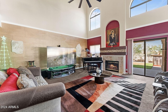 carpeted living room featuring a high ceiling and a tiled fireplace