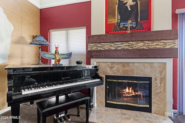 miscellaneous room with ornamental molding and a tiled fireplace