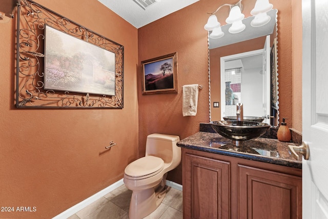 bathroom featuring tile patterned floors, vanity, and toilet