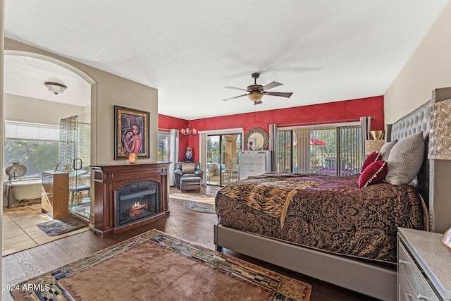 bedroom featuring hardwood / wood-style flooring, ceiling fan, a textured ceiling, and access to outside