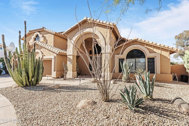 mediterranean / spanish house featuring a garage