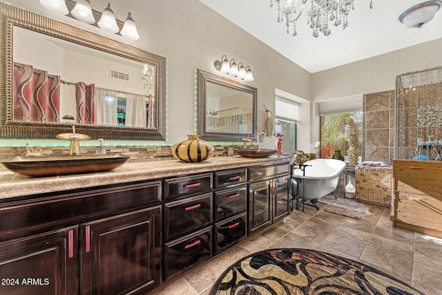 bathroom featuring a bathtub, vanity, and a notable chandelier