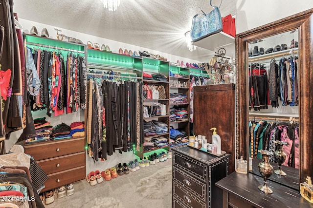 walk in closet featuring carpet flooring