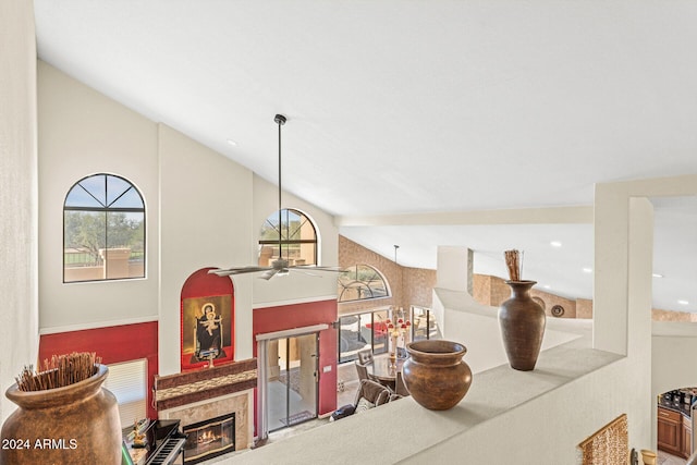 interior space with ceiling fan and vaulted ceiling