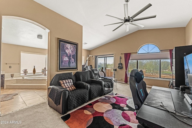 tiled living room with ceiling fan and lofted ceiling