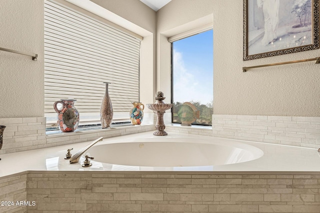 bathroom featuring a relaxing tiled tub