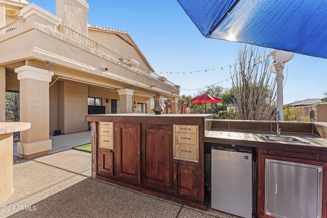 view of patio with an outdoor kitchen and an outdoor wet bar