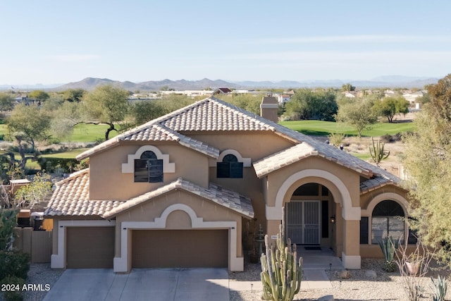 mediterranean / spanish home featuring a mountain view and a garage