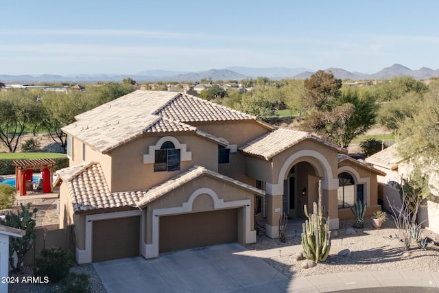 mediterranean / spanish-style house featuring a mountain view and a garage