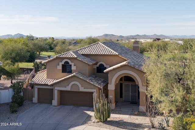 mediterranean / spanish house with a mountain view and a garage