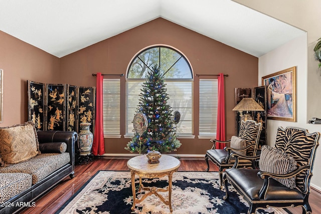 living room featuring vaulted ceiling and hardwood / wood-style flooring