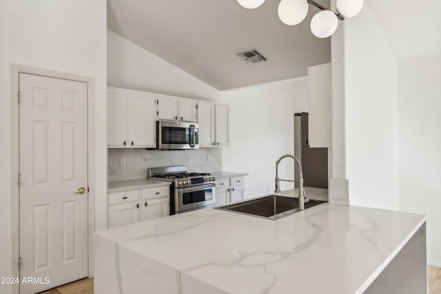 kitchen with visible vents, appliances with stainless steel finishes, white cabinetry, and a sink