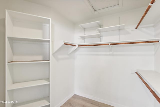 spacious closet with wood finished floors