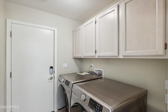 laundry room featuring cabinet space and separate washer and dryer