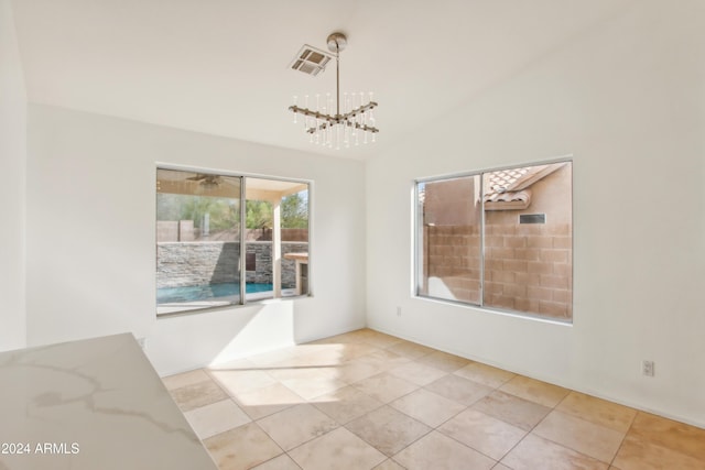 unfurnished dining area featuring tile patterned floors, visible vents, lofted ceiling, and an inviting chandelier