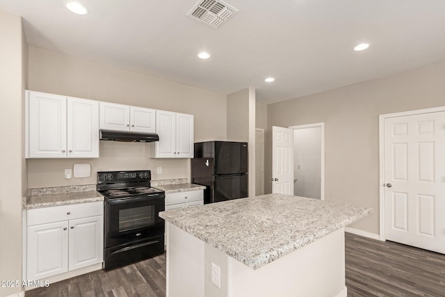 3713 S 54th Ln, Phoenix, AZ 85043 - kitchen with black appliances, under cabinet range hood, dark wood-type flooring, white cabinetry, and recessed lighting