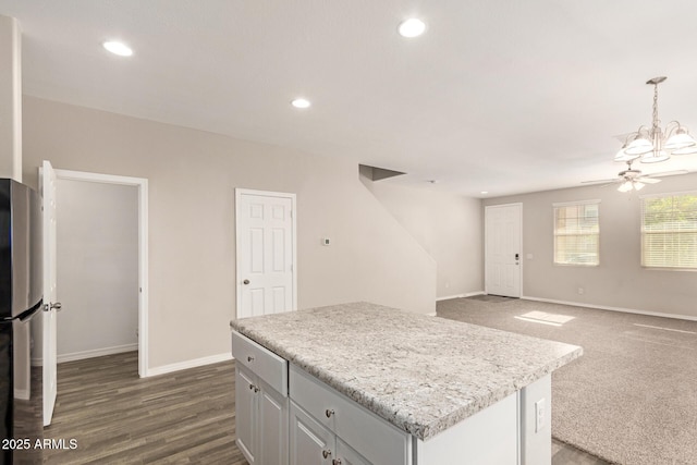 3713 S 54th Ln, Phoenix, AZ 85043 - kitchen with ceiling fan, baseboards, light countertops, a center island, and freestanding refrigerator