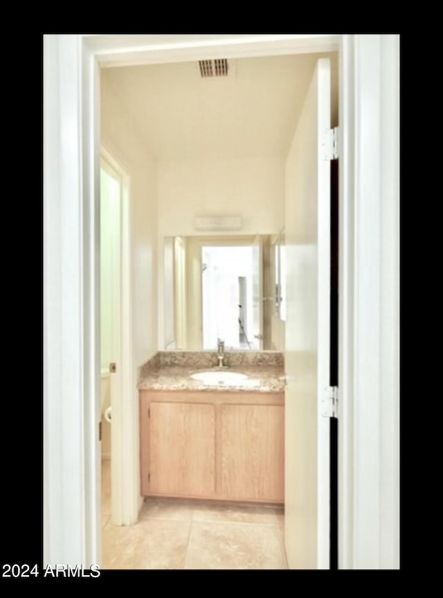 bathroom with tile patterned flooring and vanity