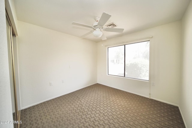 carpeted empty room with ceiling fan