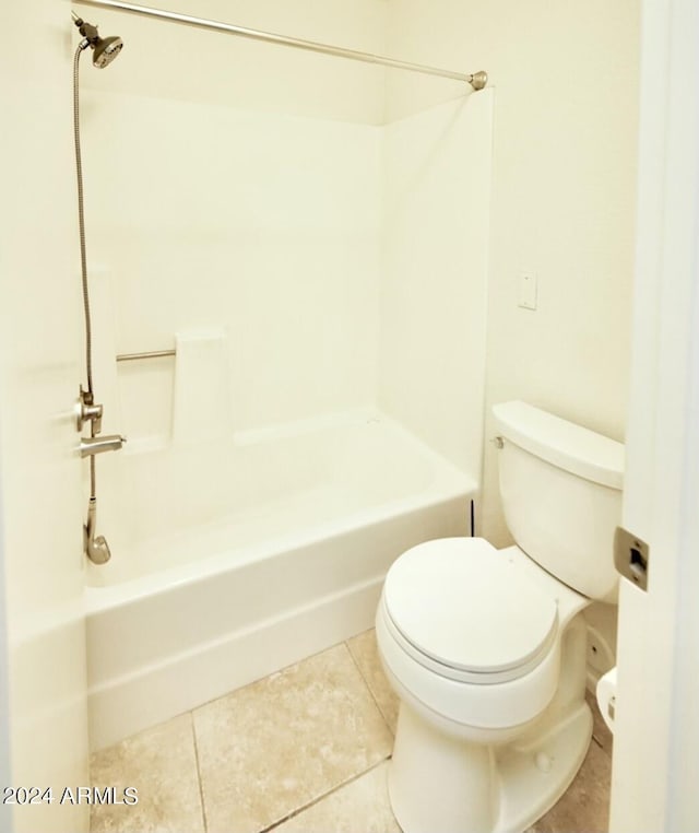 bathroom with shower / washtub combination, tile patterned flooring, and toilet