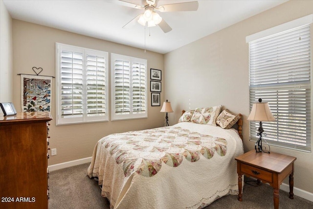 carpeted bedroom with multiple windows and ceiling fan