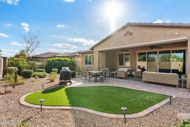 back of property with a patio area, outdoor lounge area, fence, and stucco siding