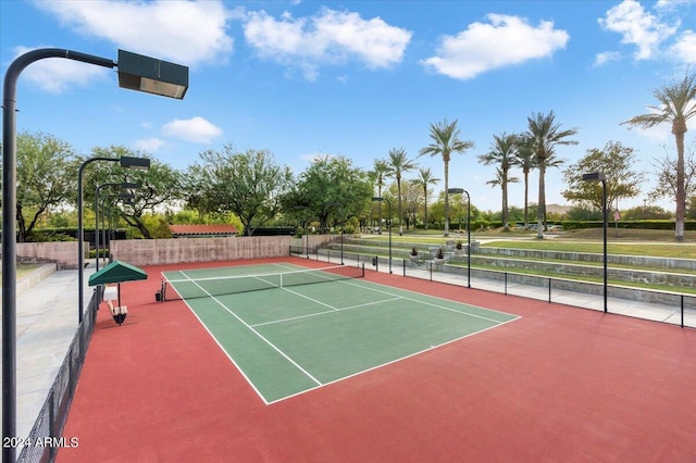 view of tennis court featuring fence