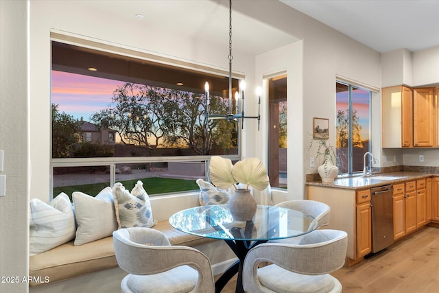 dining space featuring a chandelier and light wood finished floors