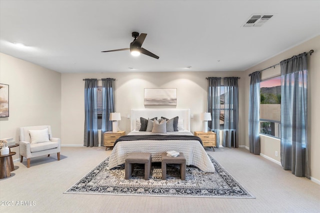 carpeted bedroom featuring baseboards, visible vents, and ceiling fan