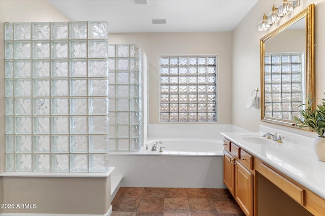 full bath featuring visible vents, a garden tub, vanity, and walk in shower