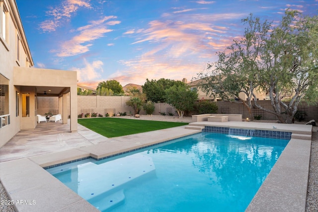 view of swimming pool with a yard, a patio area, a fenced backyard, and a fenced in pool