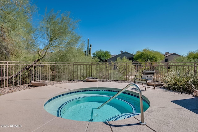 view of pool with fence, a patio, and an in ground hot tub