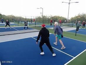 view of tennis court with fence