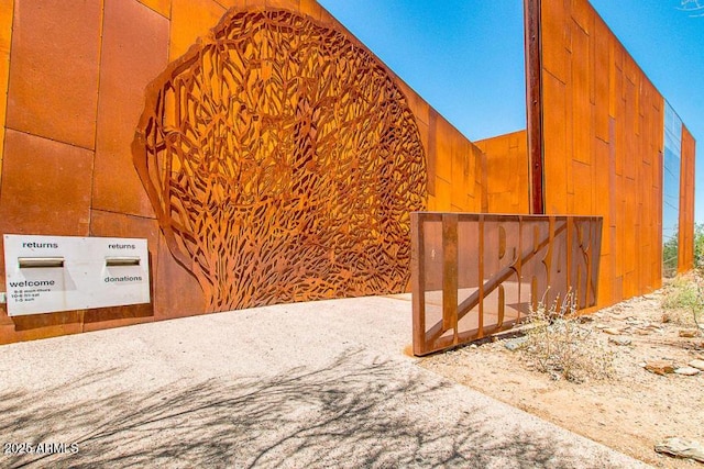 exterior space featuring lofted ceiling and wooden walls