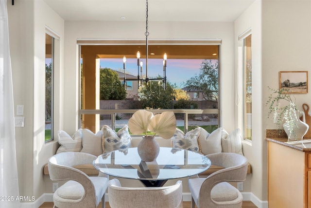 sunroom / solarium with an inviting chandelier