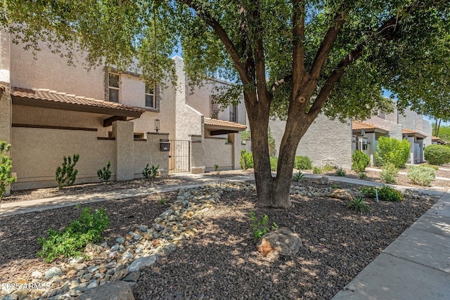 4918 N 74th St, Scottsdale, AZ 85251 - view of front facade with a gate, stucco siding, and a tile roof