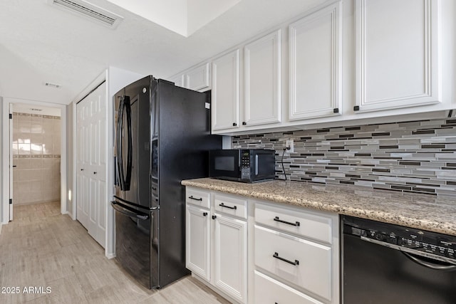 4918 N 74th St, Scottsdale, AZ 85251 - kitchen featuring black appliances, white cabinetry, light stone counters, and backsplash