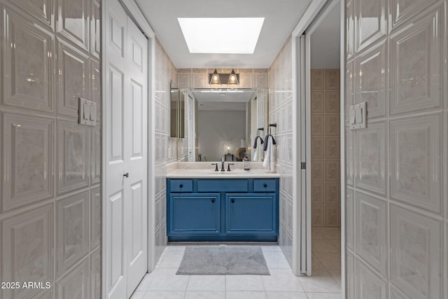 4918 N 74th St, Scottsdale, AZ 85251 - bathroom with tile patterned flooring, a skylight, vanity, and tile walls