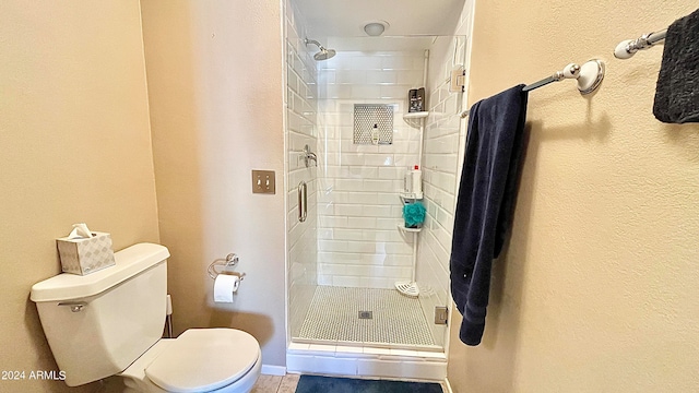 bathroom featuring toilet and walk in shower