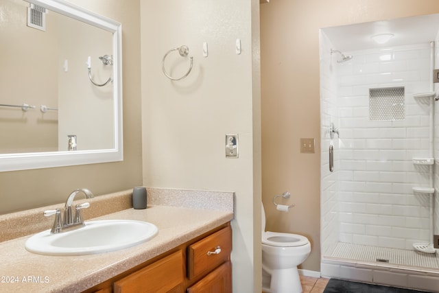 bathroom featuring a shower with shower door, toilet, tile floors, and vanity with extensive cabinet space