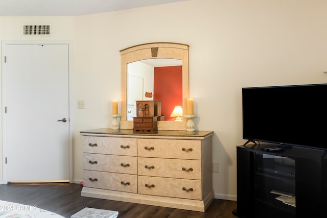 bedroom with dark hardwood / wood-style flooring