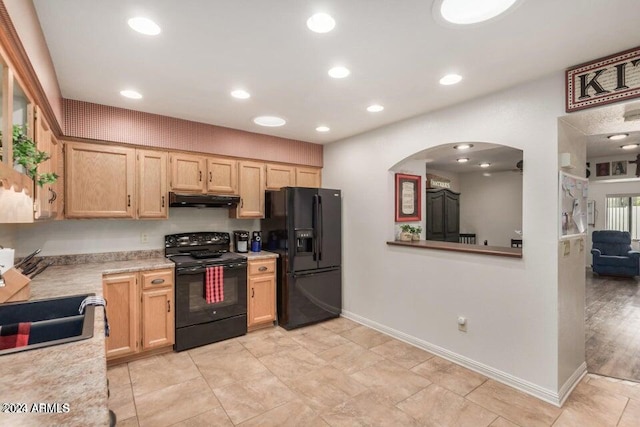 kitchen with light brown cabinets, sink, light tile flooring, and black appliances