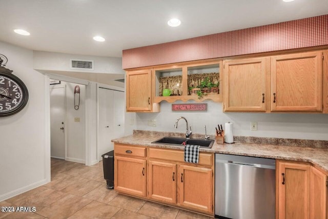 kitchen featuring sink, light tile floors, and stainless steel dishwasher