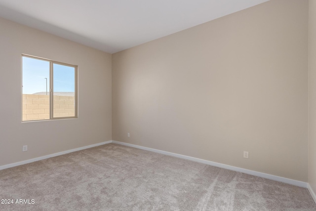 carpeted spare room with baseboards