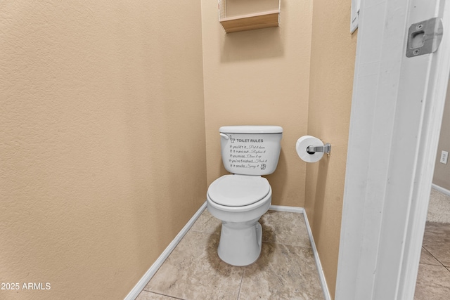 bathroom with toilet and tile patterned floors