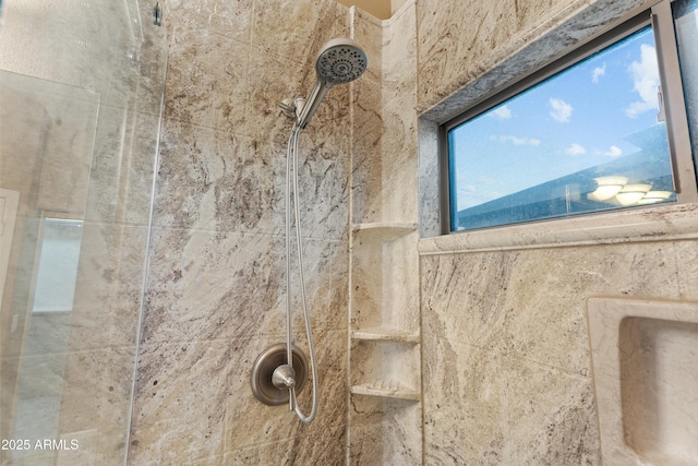 interior details featuring a tile shower