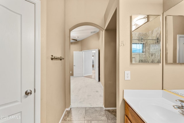 bathroom featuring a shower and vanity